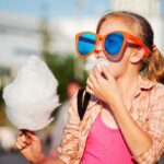 girl eating cotton candy