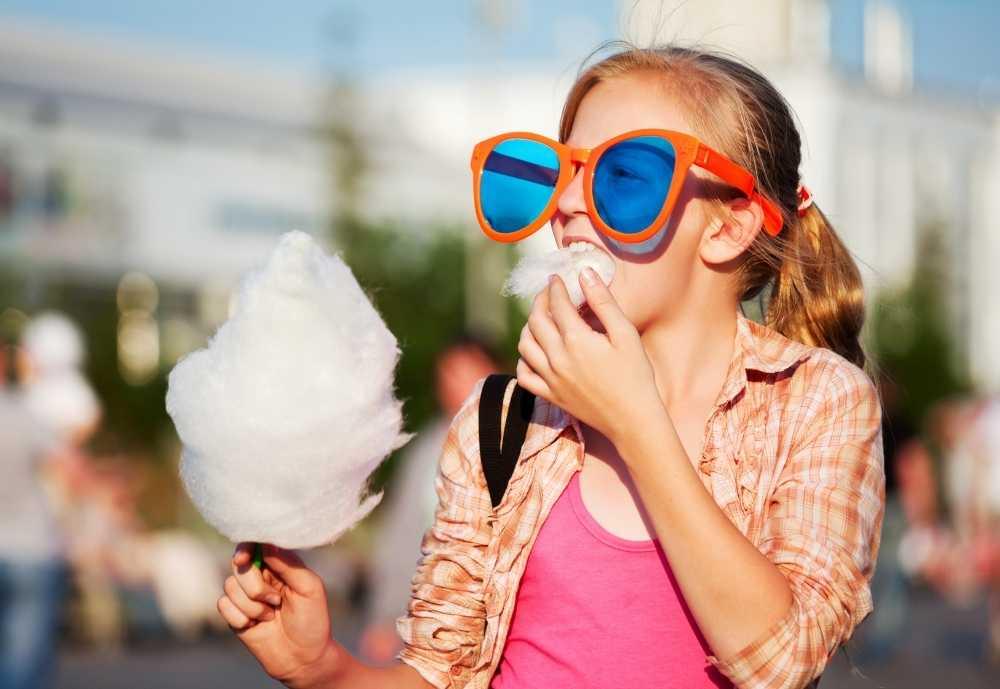 girl eating cotton candy